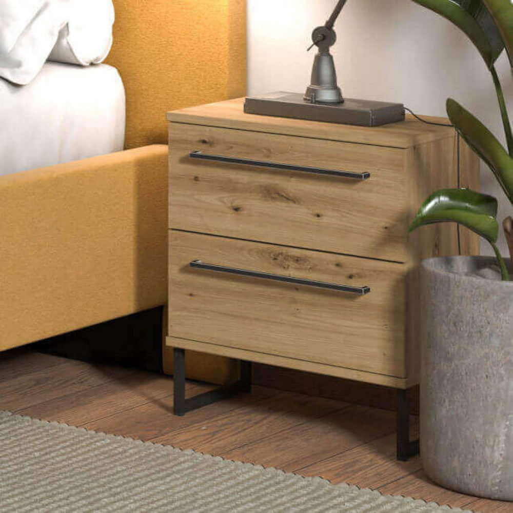 Inquadratura laterale del comodino in rovere chiaro inserito in una camera da letto dal design moderno.