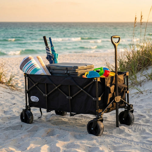 Carrello Black Sea in metallo e poliestere nero, posizionato sulla sabbia con asciugamani e accessori da spiaggia.