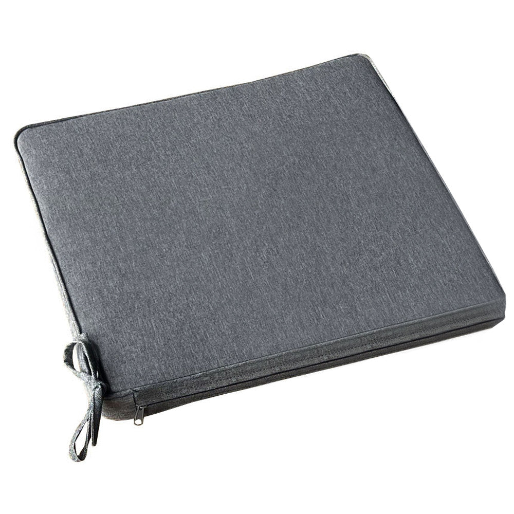 Vista angolata del cuscino sfoderabile grigio scuro melange con focus sulle finiture sartoriali.