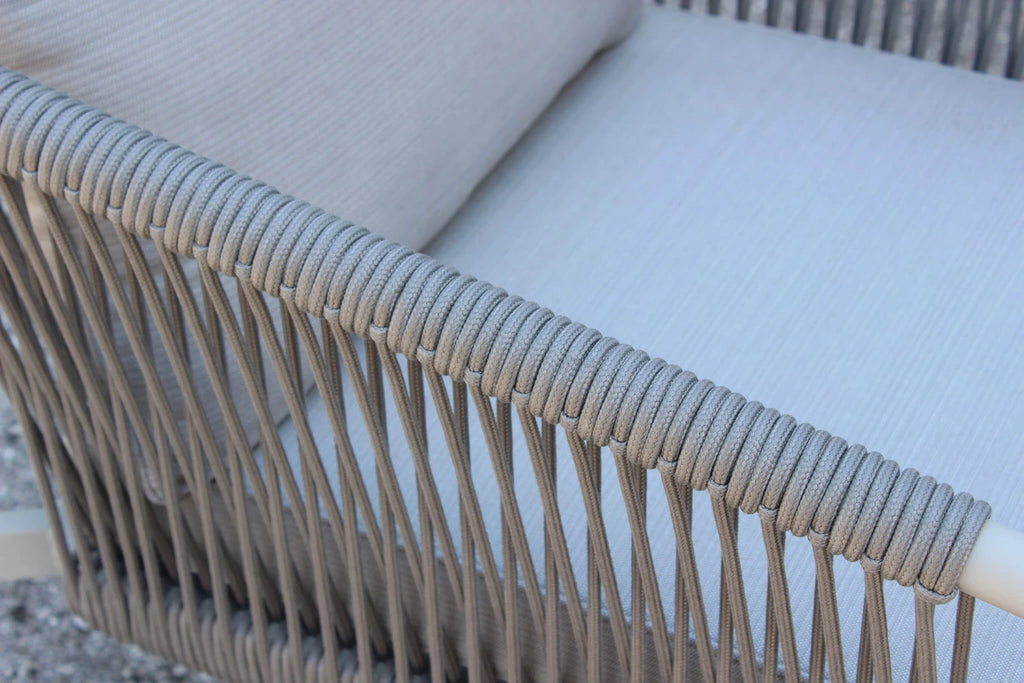Primo piano del bracciolo di una poltrona del salotto Mumbai, che evidenzia l'intreccio della corda tonda sintetica e lo spessore del cuscino
