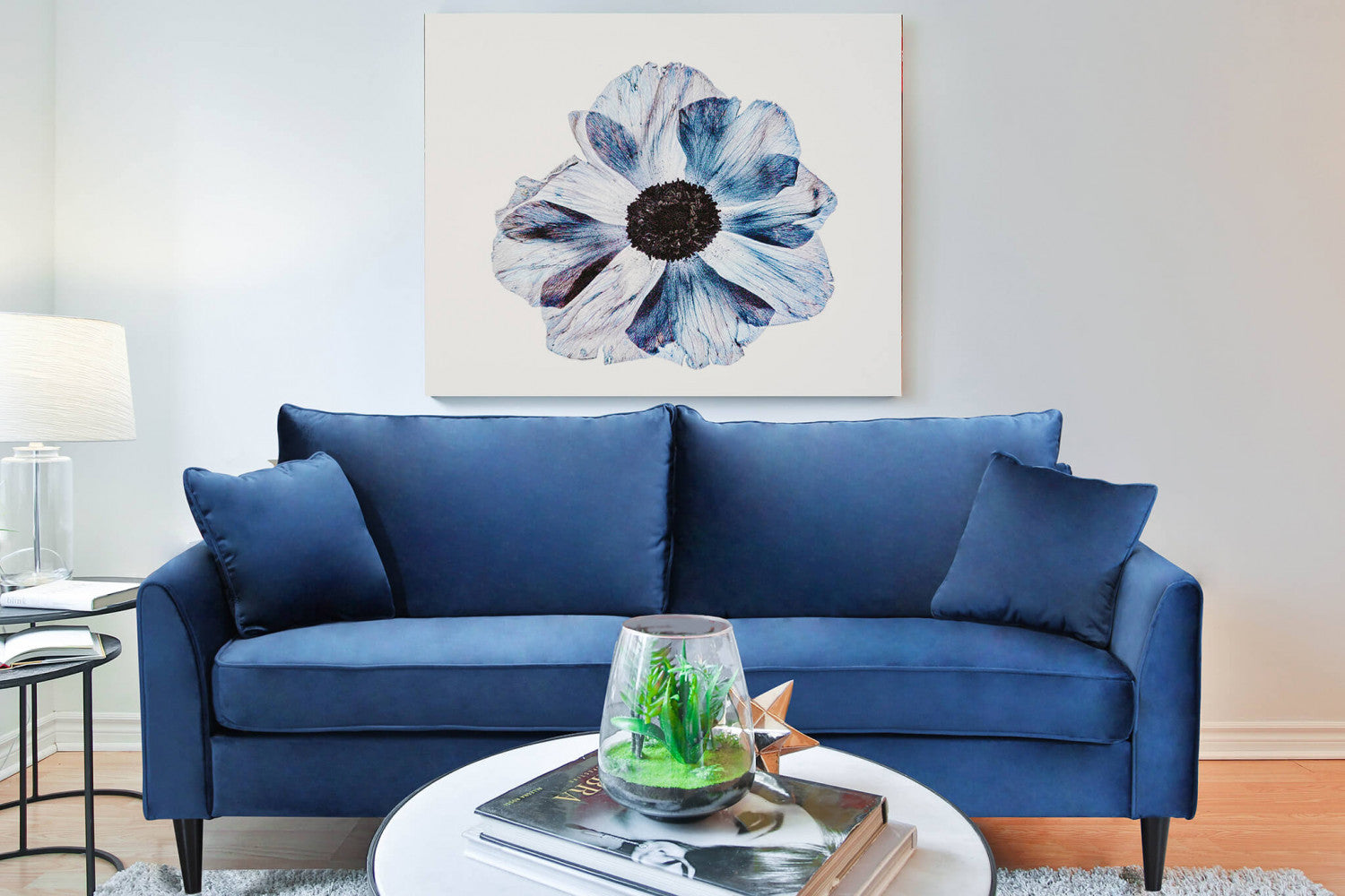 Divano Chandler ambientato in un salotto elegante con un grande quadro floreale a parete.