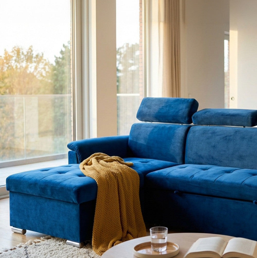 Dettaglio del divano in tessuto blu con plaid senape in un ambiente elegante.