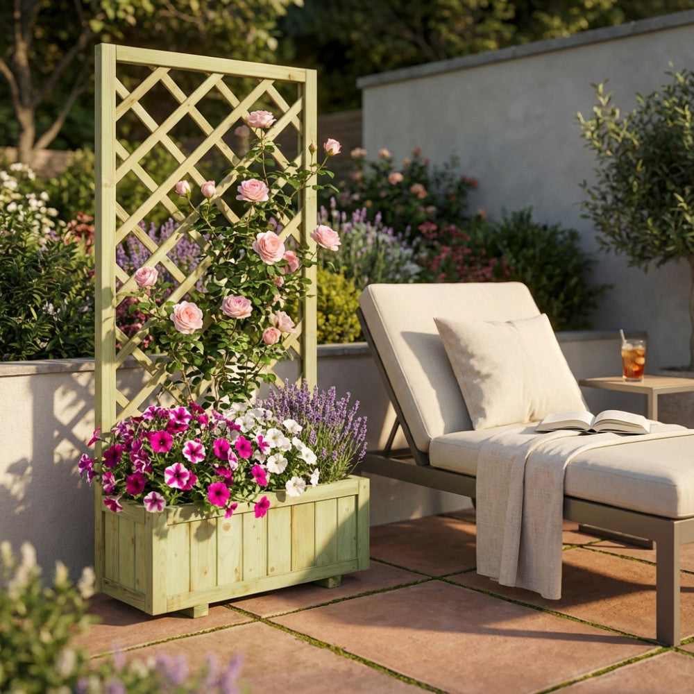 Fioriera da esterno in legno marrone con rose rampicanti e petunie, situata su un patio pavimentato vicino a una chaise longue di design.