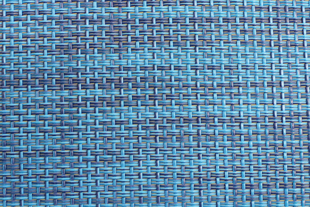 Dettaglio ravvicinato della trama del tessuto tecnico blu melange, che mostra l'intreccio robusto e la finitura premium della seduta.
