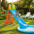 Bambina che gioca sul mega scivolo Cosma Mega Scivolo Con Acqua blu e arancione