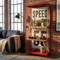 Mobile bar Clayton in metallo rosso e legno ambientato in un loft industriale con divano scuro e lampada da terra.