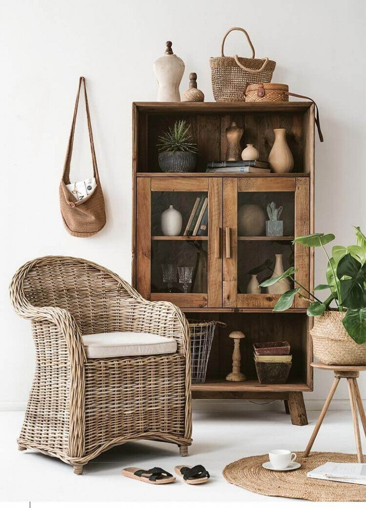Credenza Elvin inserita in un contesto rustico-chic con poltrona in rattan e accessori in fibre naturali.