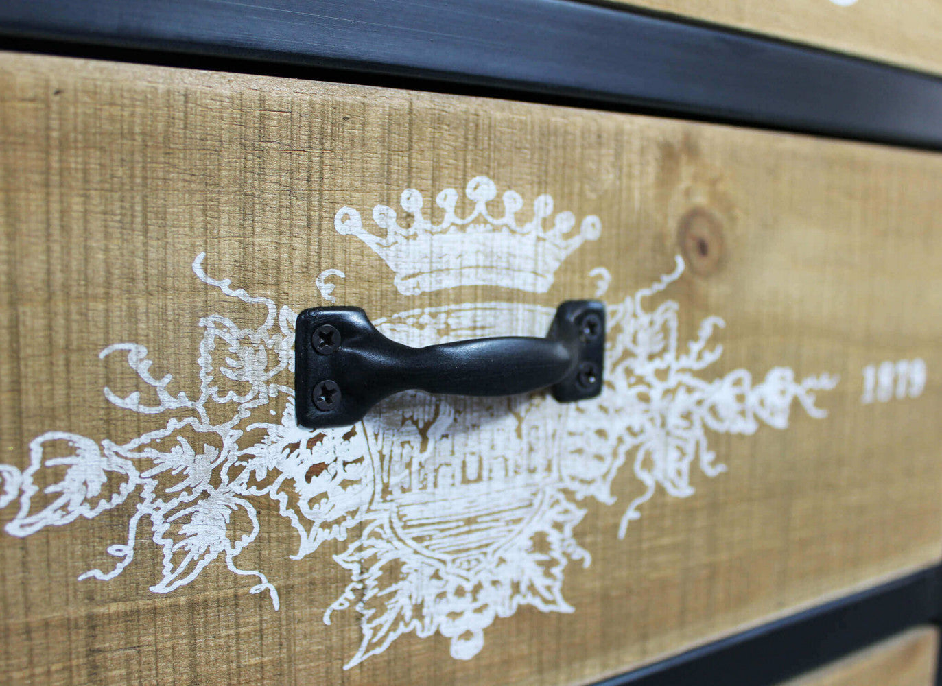 Dettaglio della maniglia in metallo nero sul cassetto in legno stampato.