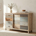 Credenza Harry in legno multicolore ambientata in un living luminoso con vaso decorativo.