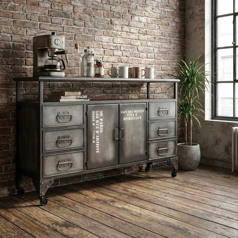 Credenza Emeric ambientata in una cucina industriale con macchina da caffè e piante decorative.