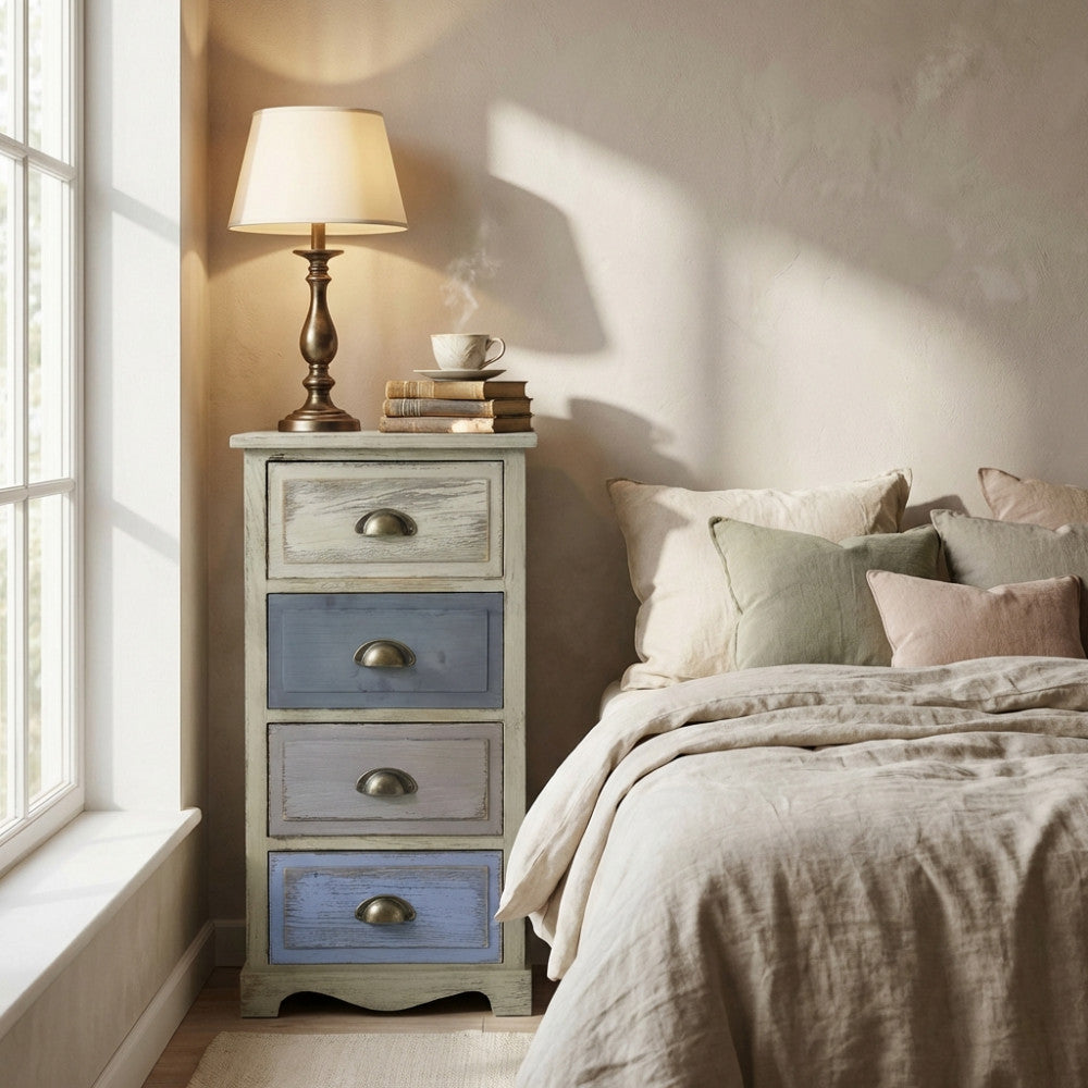 Comodino Chico a quattro cassetti in stile shabby chic, ambientato in una luminosa camera da letto accanto a una finestra.