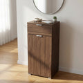 Mobiletto MR805006 in finitura noce ambientato in un ingresso luminoso con specchio circolare e decorazioni minimaliste.