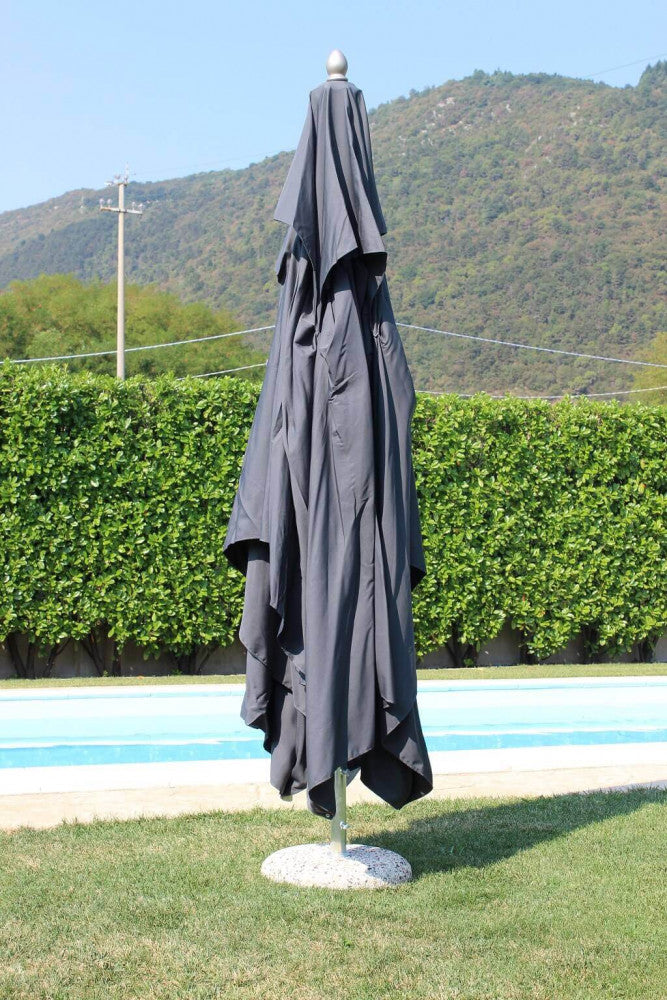 Ombrellone da giardino chiuso con telo in poliestere grigio, posizionato a bordo piscina.