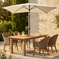 Ombrellone Cosma Poly Eco 2x3 ecrù aperto su tavolo da giardino in legno