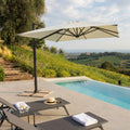 Ombrellone Stephenson aperto a bordo piscina con telo beige e palo laterale nero.