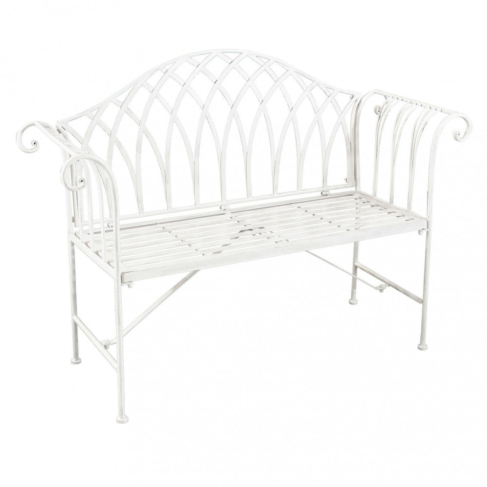 Panca Annette in metallo verniciato a polvere colore bianco antico, posizionata in un giardino.