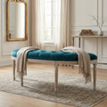 Panca Margi in velluto blu e legno posizionata in un ingresso elegante con specchio dorato.