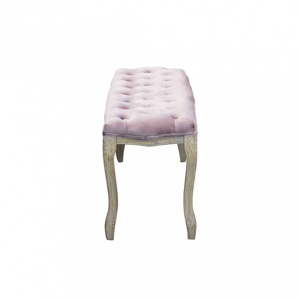 Profilo laterale della panca in velluto rosa che evidenzia la curvatura elegante delle gambe.