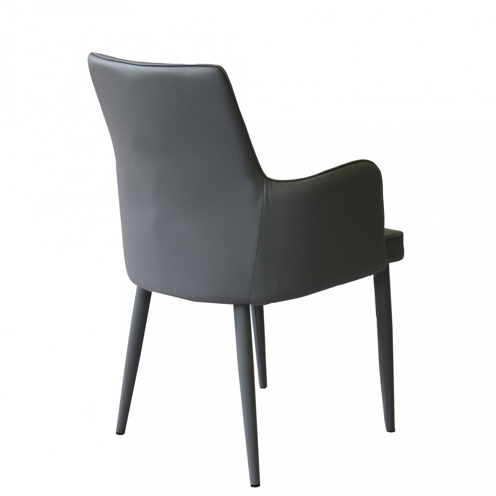 Poltrona Camille Grigio Scuro con braccioli, panoramica sinistra in un ambiente di ufficio o studio.