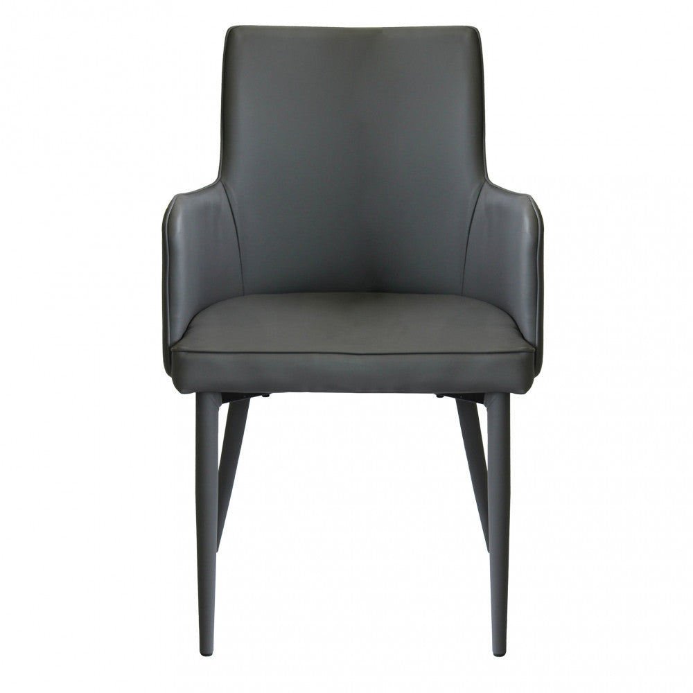 Poltrona Camille Grigio Scuro in ecopelle imbottita, inserita in un contesto di salotto moderno.