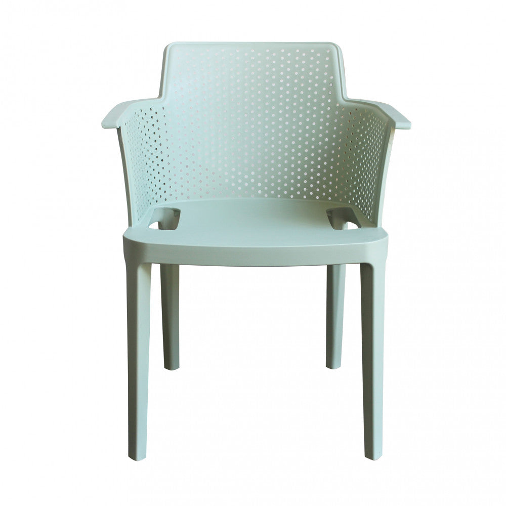 Vista frontale perfettamente simmetrica della poltrona Cathy verde menta che mostra l'ergonomia dello schienale.