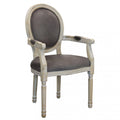 Poltrona Constance imbottita in velluto color taupe, con braccioli e struttura in legno vintage, perfetta per salotti moderni