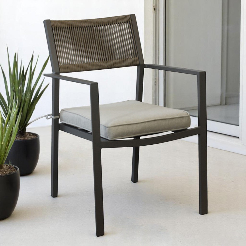 Poltrona Maracay ambientata in un patio moderno con pavimentazione chiara e piante decorative.