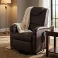 Poltrona relax elettrica in ecopelle marrone ambientata in un salotto elegante con coperta e libro