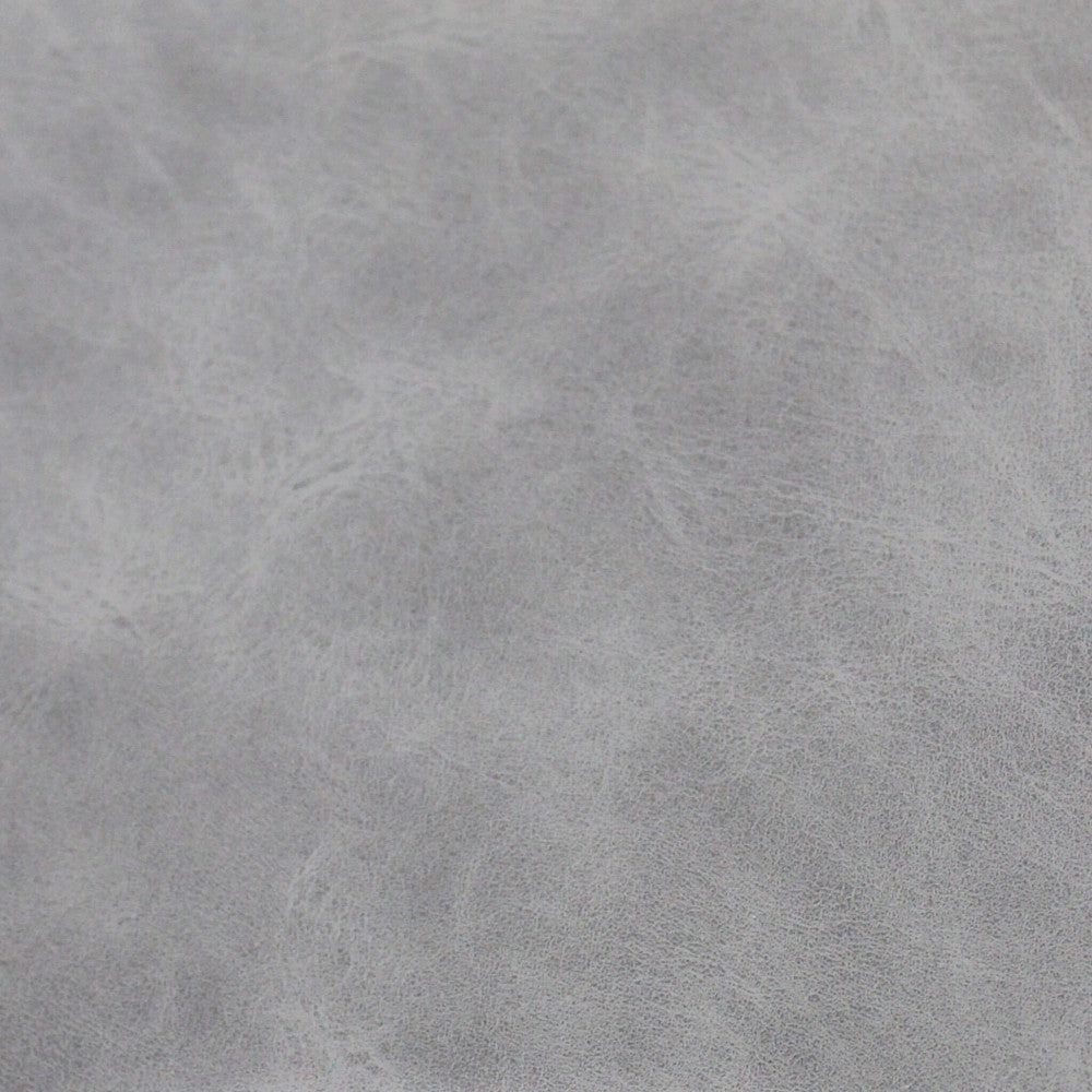 Primo piano della texture in ecopelle premium color tortora che mostra le venature e la finitura tattile