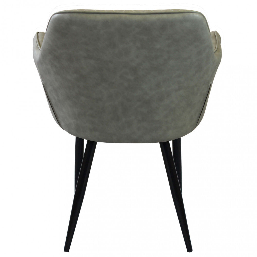 Vista posteriore della poltrona Sindy, che mostra il design pulito dello schienale in ecopelle tortora e le gambe affusolate.