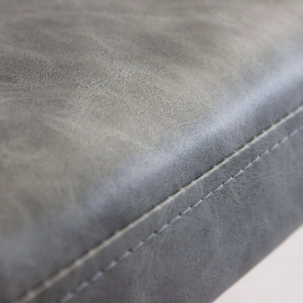 Poltrona Sissy in ecopelle grigia, seduta imbottita con telaio in metallo, particolare della seduta