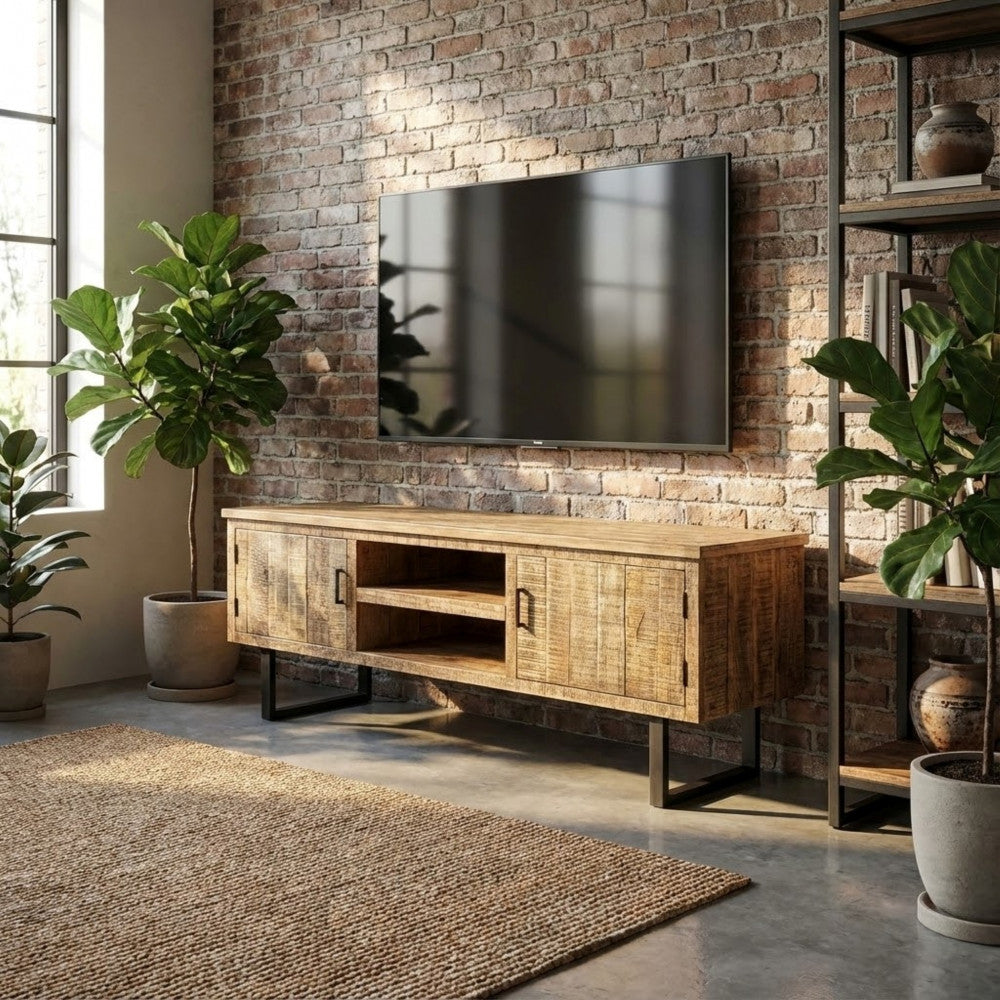 Ambientazione loft industriale con il Porta TV BEVIS contro una parete in mattoni rossi e piante decorative.