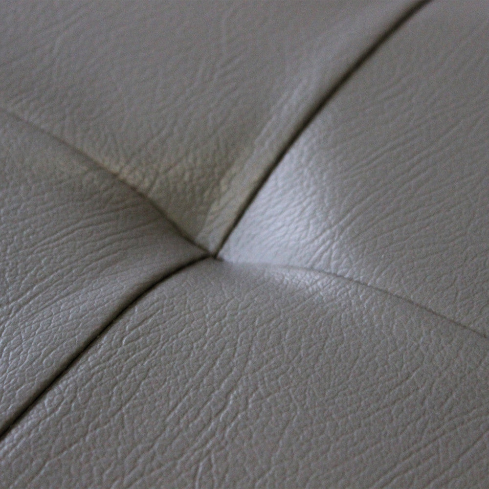 Macro dettaglio della texture in ecopelle grigio che evidenzia la qualità del materiale.