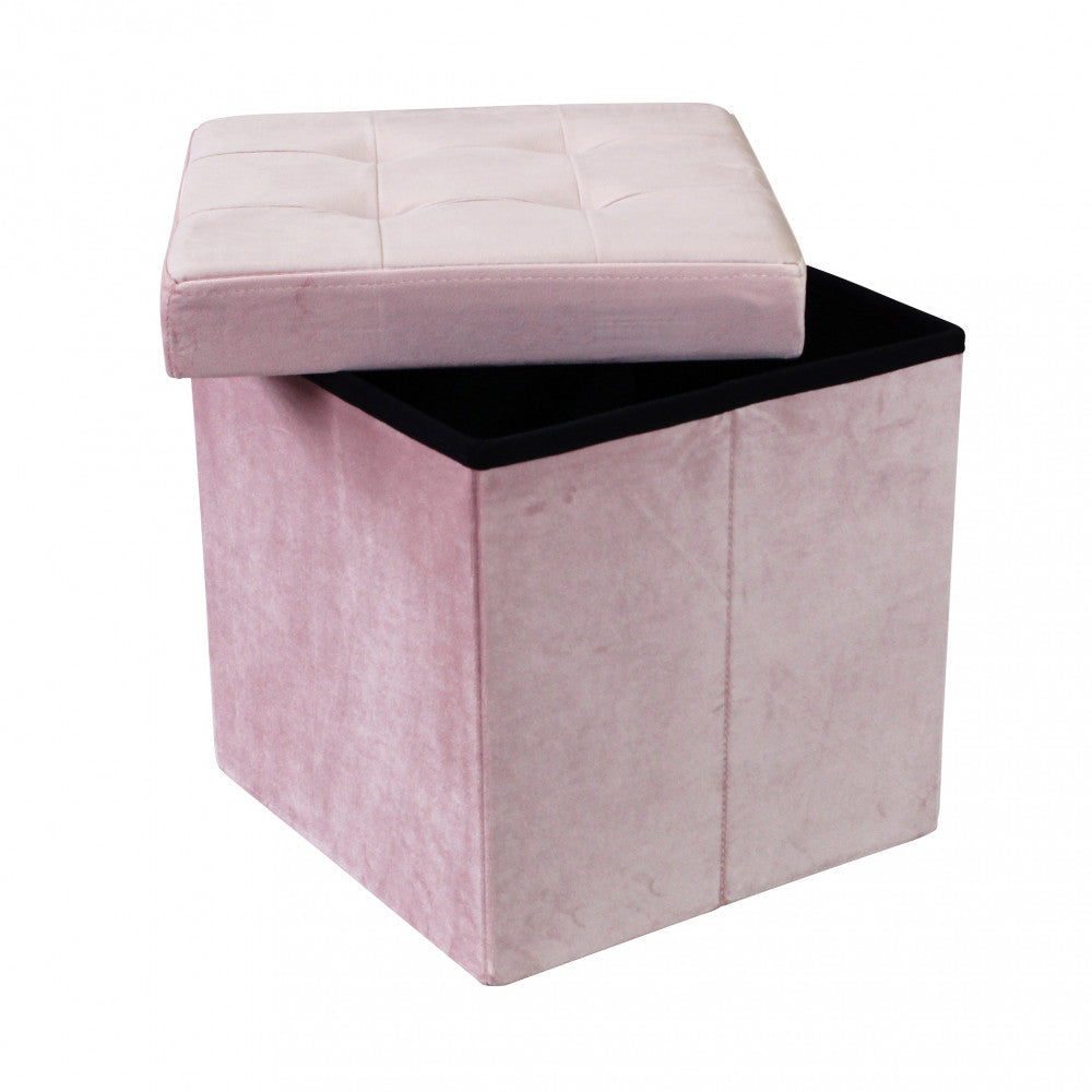 Pouf contenitore rosa con il coperchio appoggiato in diagonale, rivelando lo spazio di archiviazione interno.