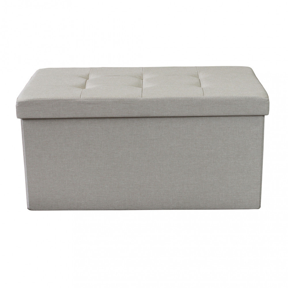 Prospettiva angolare del pouf contenitore rettangolare, evidenziando la texture del tessuto tortora.