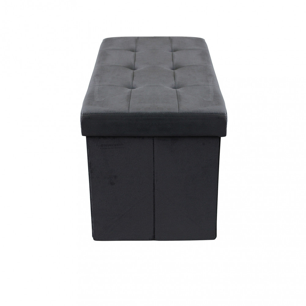 Profilo laterale del pouf contenitore in velluto nero, che mostra le linee geometriche e le cuciture precise.