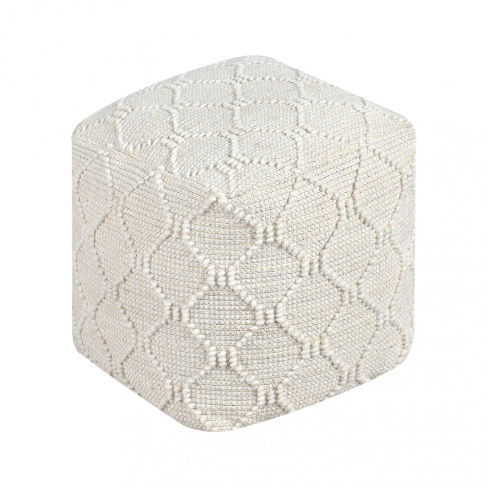 Vista frontale del Pouf Méliton su sfondo bianco, che evidenzia la trama geometrica in lana e juta.