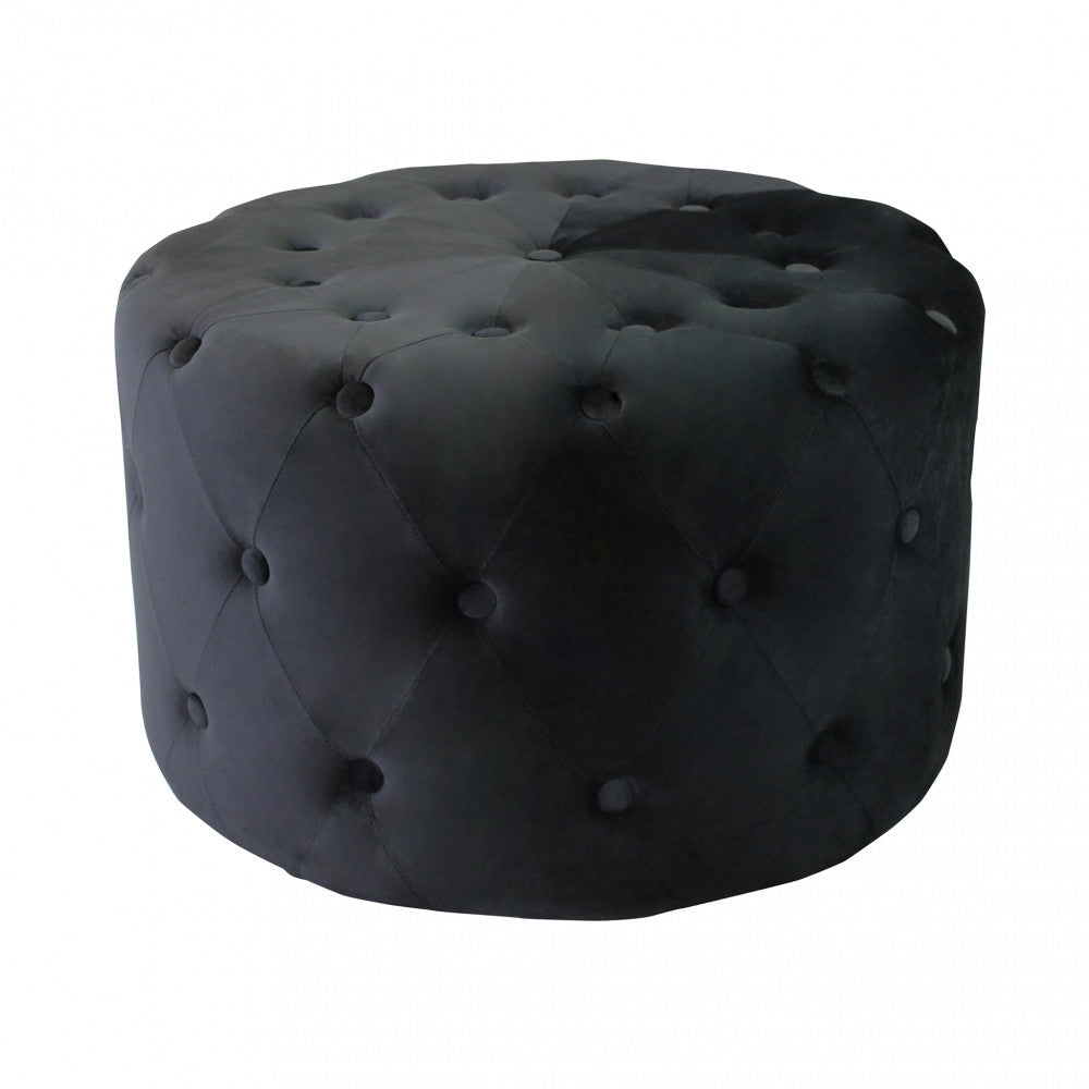 Vista frontale del pouf rotondo in velluto nero, che evidenzia la precisione dei bottoni capitonné.