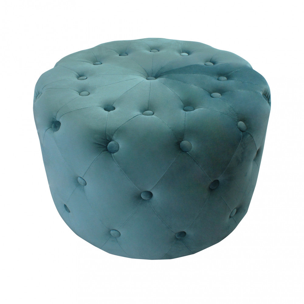 Vista dall'alto del pouf rotondo in velluto verde, che evidenzia la simmetria del design capitonné.