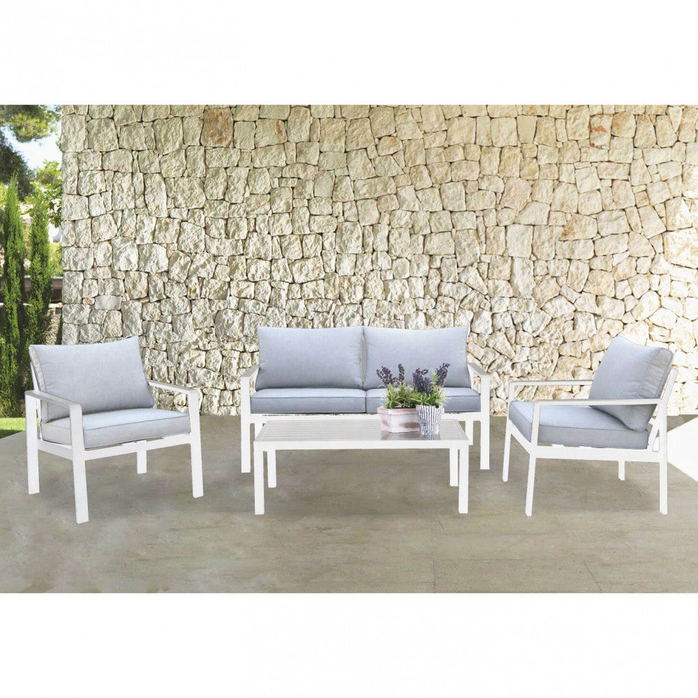 Il salotto Santo Domingo posizionato su una terrazza con muro in pietra a secco, esaltando il contrasto materico.
