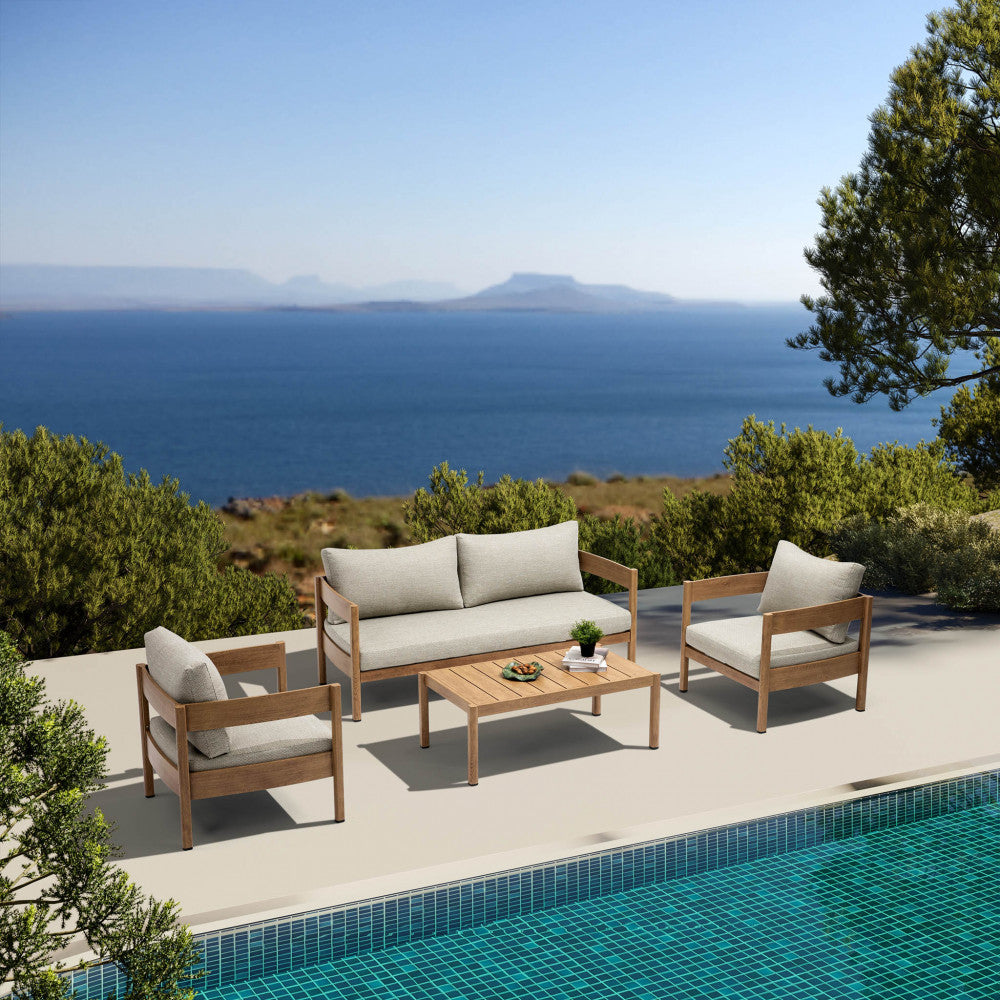 Set salotto Bridgetown posizionato a bordo piscina con vista panoramica sul mare, evidenziando i volumi geometrici della struttura.