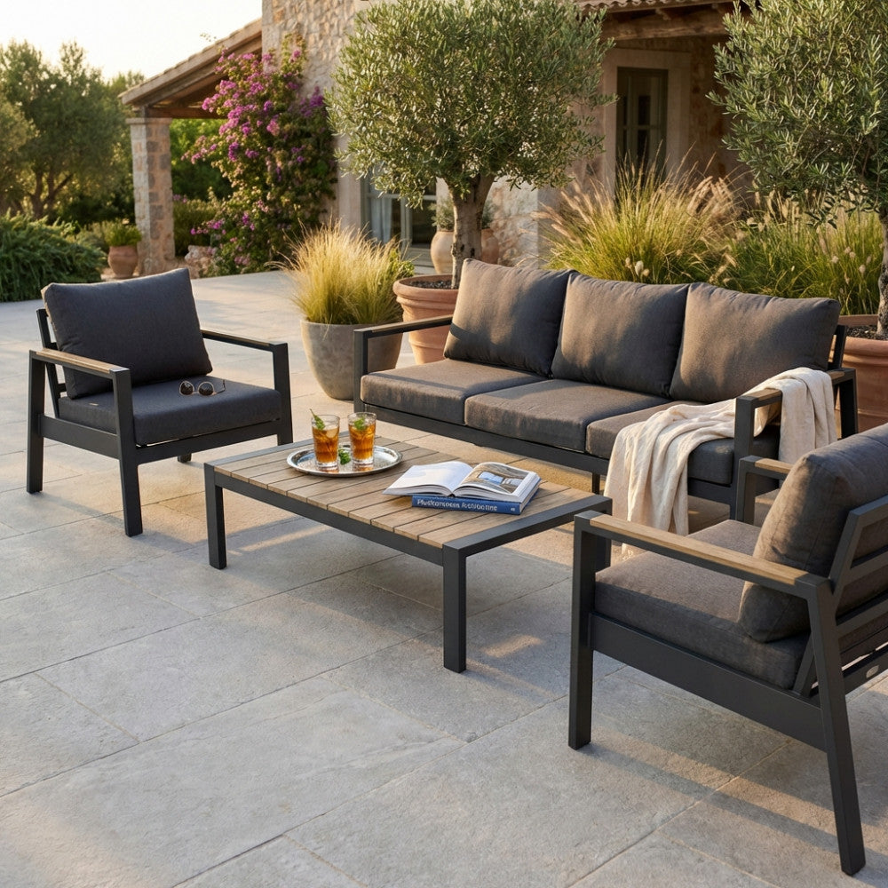 Salotto Córdoba a 5 posti in polywood marrone e poliestere antracite, allestito su un patio in pietra naturale al tramonto.