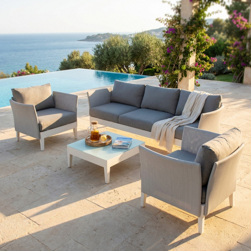 Salotto da esterno Minneapolis a 5 posti in alluminio bianco e textilene grigio, allestito a bordo piscina con vista mare.