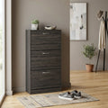 Scarpiera in legno grigio scuro ambientata in un ingresso moderno con decorazioni minimaliste.