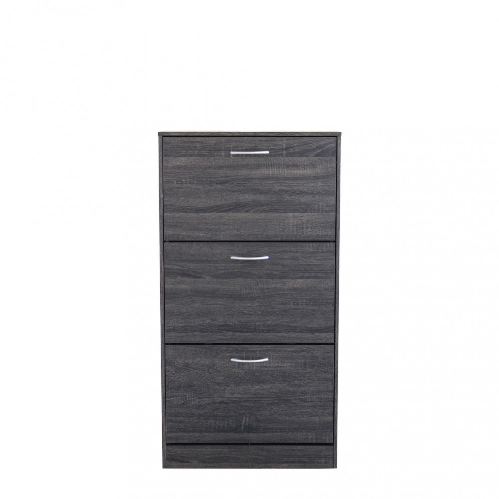 Vista frontale della scarpiera in legno grigio scuro con cassetti chiusi su sfondo bianco.