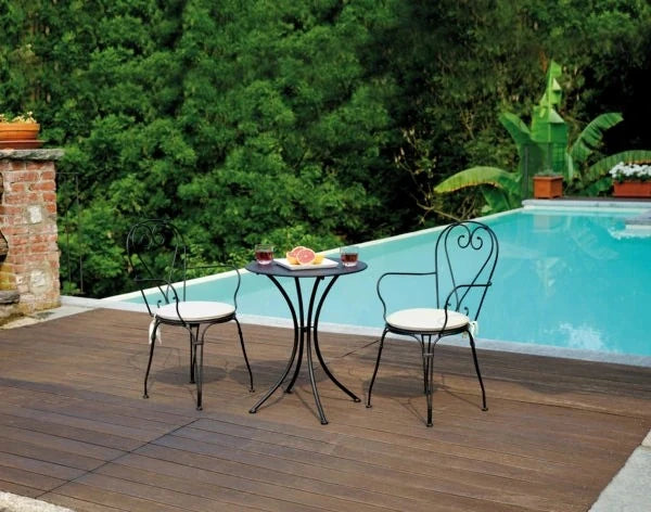 Sedia Stresa Antracite con braccioli in ferro con verniciatura antiruggine, impilabile per esterni, abbinata a bordo piscina