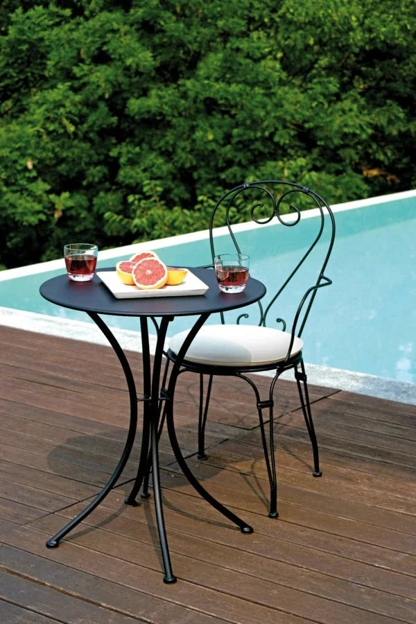 Sedia Stresa Antracite con braccioli in ferro con verniciatura antiruggine, impilabile per esterni, abbinata con tavolino a bordo piscina