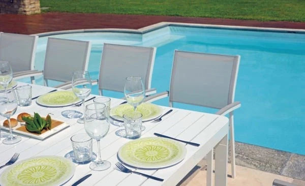 Sedia Volterra/Viareggio CHA22B in Alluminio Bianco con seduta Textilene Tortora, braccioli in Resin Wood Grigio Sbiancato e impilabile, ambientata a bordo piscina