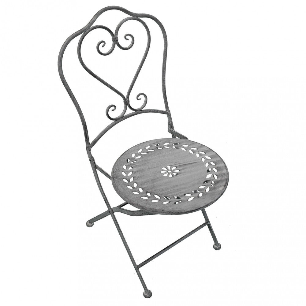 Sedia pieghevole del set bistrot Jeanette con schienale a cuore e seduta decorata, isolata su sfondo bianco.