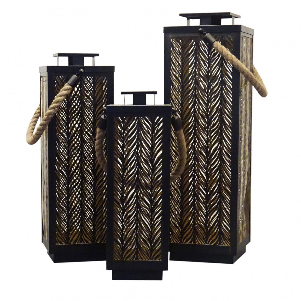 Set di 3 lanterne Danielle in metallo nero con interno oro e manico in corda, diverse altezze.